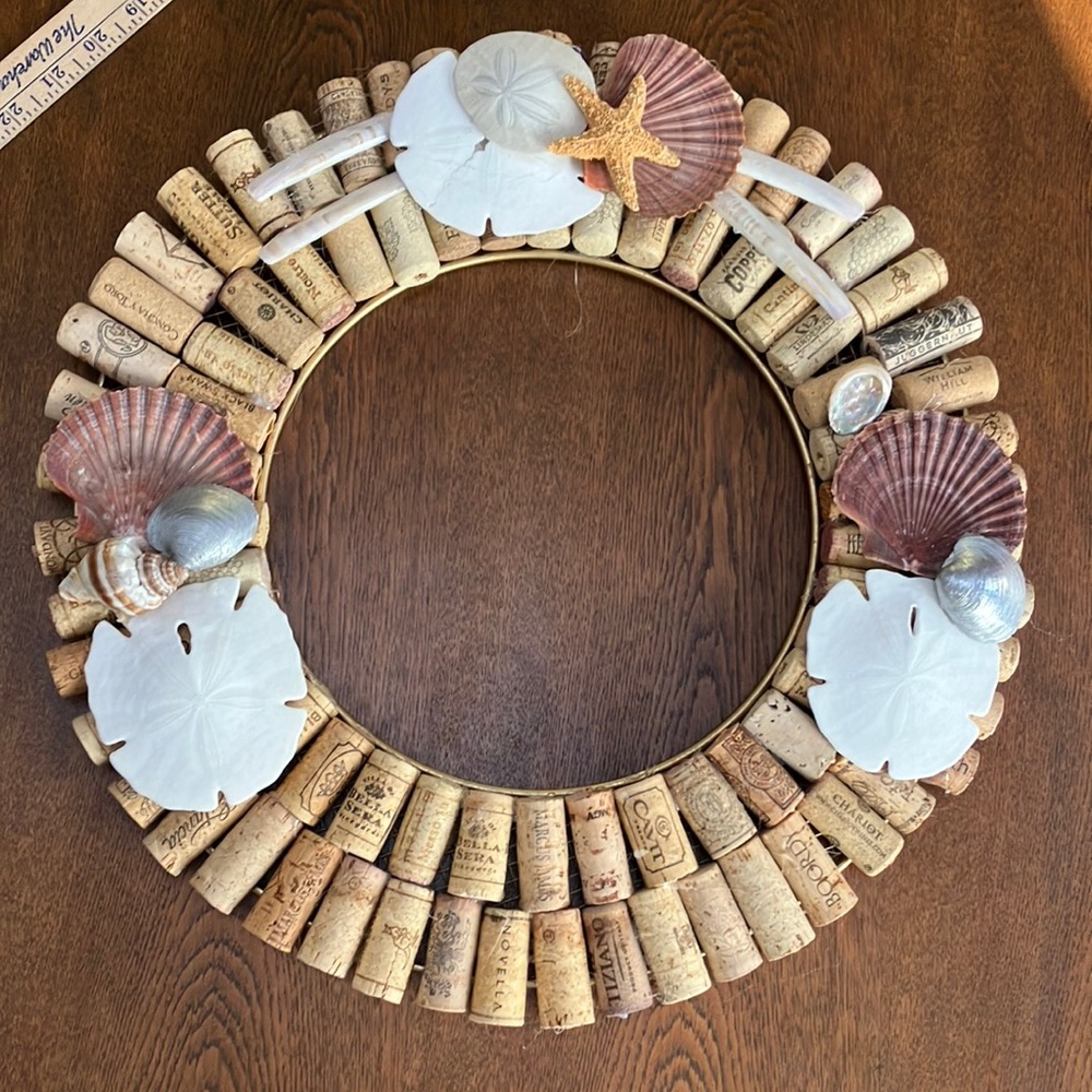 17” wine cork w/ seashells, sand dollars, starfish decor on wire frame.